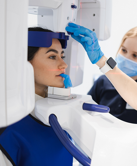 Dental patient getting a C T cone beam scan of her mouth and jaws