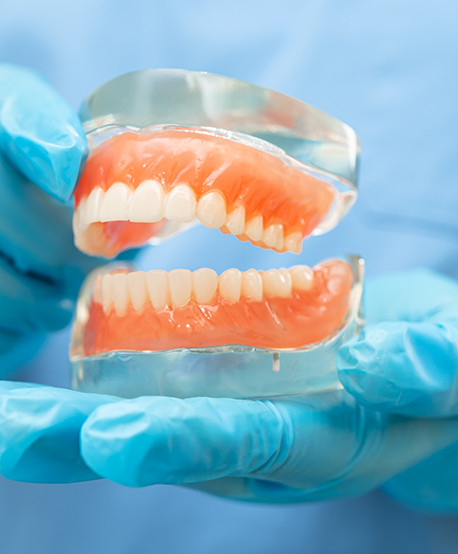 Dentist holding a model of dentures