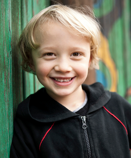 Smiling child with curly blond hair