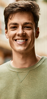 Smiling young man in a light green shirt
