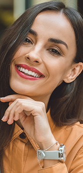Smiling woman in an orange blouse