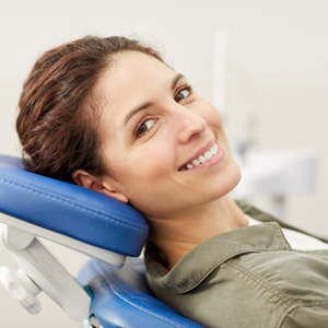 Woman smiling while relaxing in treatment chair
