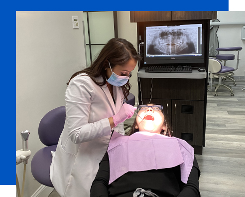 Our Westbury dentist examining a patient's mouth
