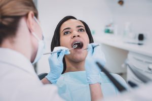 dentist evaluating patient's teeth